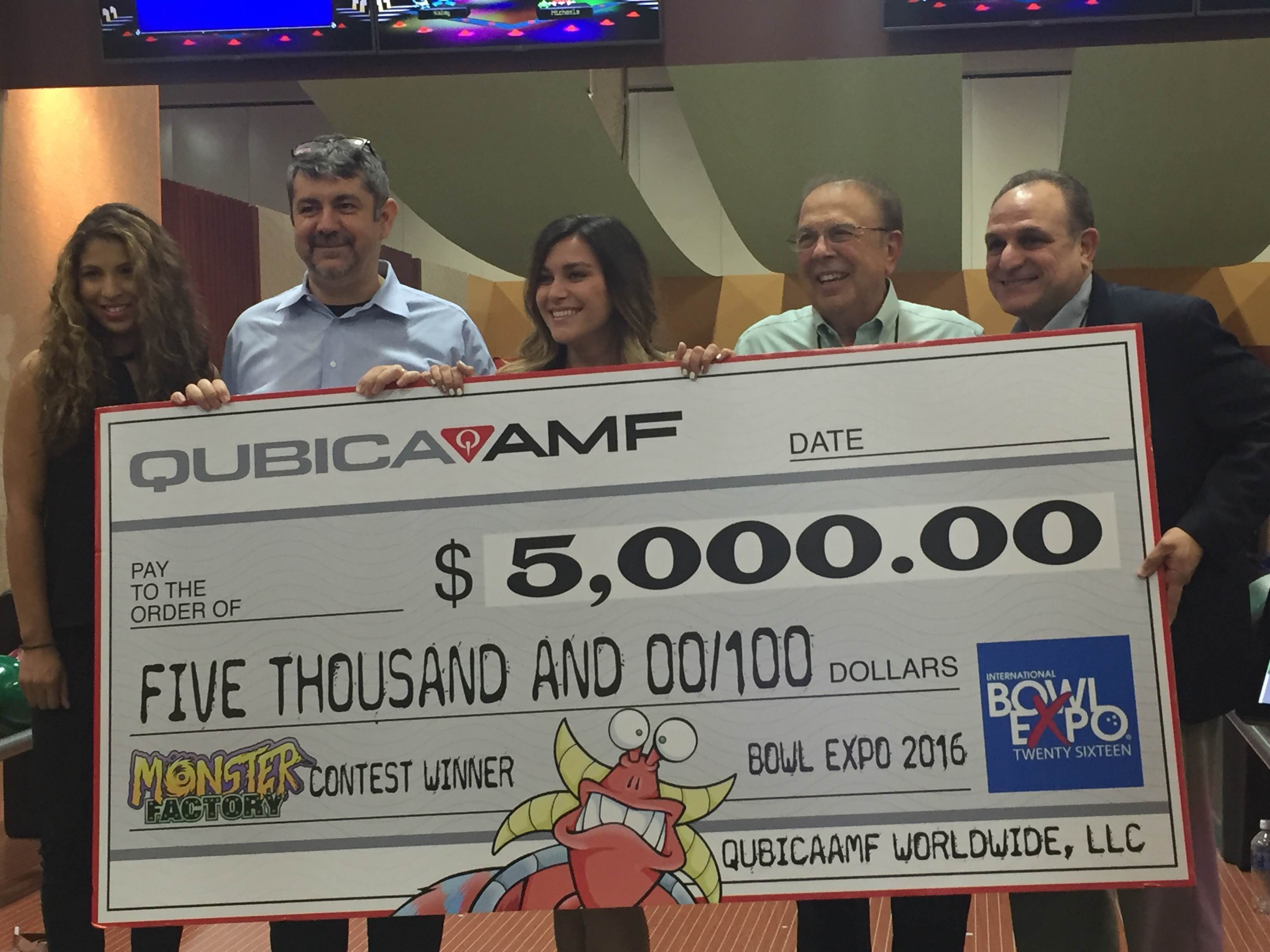 Image: Left to right, booth hostess, Emanuele Govoni, CEO, QubicaAMF, Alaina Crabtree, contest winner, Pat Ciniello, chairman of the board, QubicaAMF, Juan Cabezas, president and chief growth officer, QubicaAMF