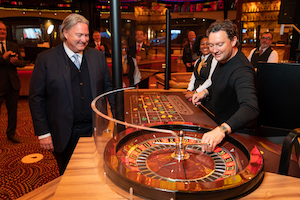 The reopening at Holland Casino Centrum with singer Tino Martin spinning the roulette wheel watched by CEO Erwin van Lambaart. (Photo: Holland Casino / Michel Schnater)