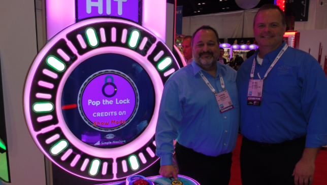 Adrian Drewitz (left) is joined by successor Mark Lenske at one of Bay Tek’s new machines, Pop the Lock