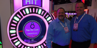 Adrian Drewitz (left) is joined by successor Mark Lenske at one of Bay Tek’s new machines, Pop the Lock