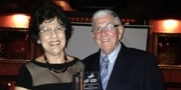 Jacqueline Fletcher receiving the award from LAI chairman Malcolm Steinberg